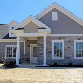 Modern single-story house with stone and siding exterior.