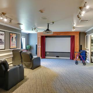 A stylish home theater featuring comfortable seating and a large projection screen, perfect for movie nights.