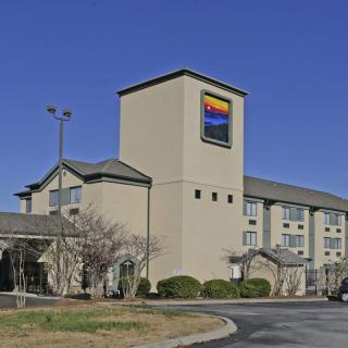 Exterior view of a hotel building with clear skies.