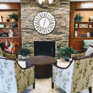 A cozy living room setup featuring elegant chairs, a central table, and tasteful decor.