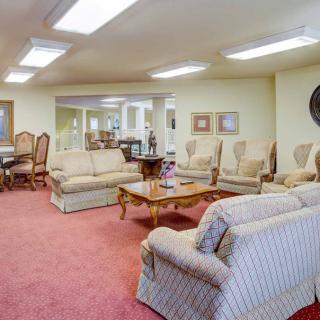 A spacious living area with comfortable seating arrangements and elegant furniture.