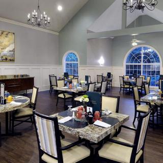 A stylish dining area with elegant chandeliers and well-arranged tables.