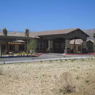 A building in a desert landscape on a sunny day.