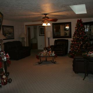 A cozy living room decorated for the holidays with a Christmas tree and festive decorations.
