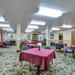 Spacious dining area with tables and chairs set for guests.