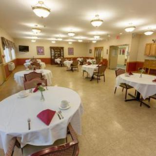 A spacious dining area with elegantly set tables, ready for guests.