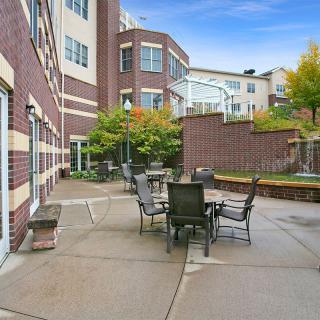 Outdoor patio area with seating near an apartment building.