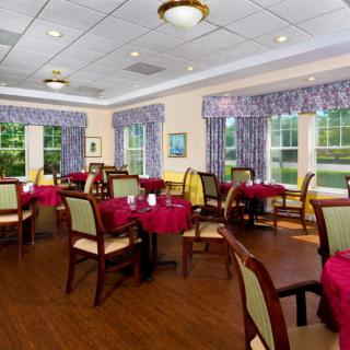 A well-decorated dining room with neatly arranged tables and comfortable seating.