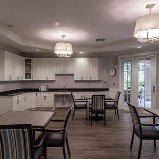 A modern kitchen and dining area featuring sleek cabinets, contemporary lighting, and stylish furniture.