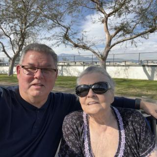A selfie of two people enjoying a sunny day outside.