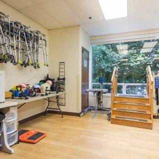 A physical therapy room equipped with exercise tools and a small staircase for rehabilitation exercises.