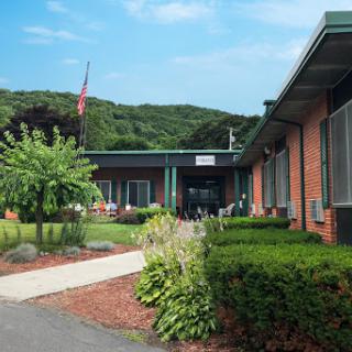 A well-maintained educational facility surrounded by lush greenery.