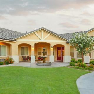 A beautiful suburban house with a well-maintained front lawn.