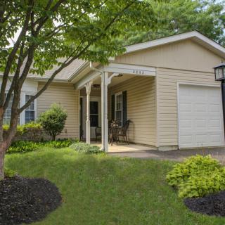 A cozy single-story house with a well-maintained front yard and garden.