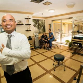 A professional smiling confidently in an office setting.
