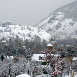 A snowy village nestled in the mountains during winter.