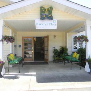 A welcoming entrance to a building with decorative plants and seating area.