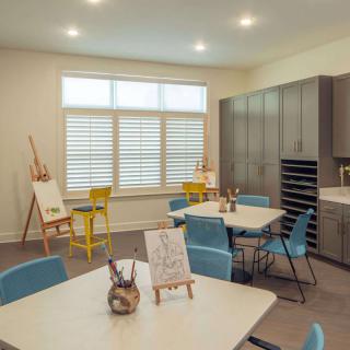 An inviting art studio with tables, easels, and comfortable seating.