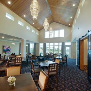 A spacious dining area with high ceilings and elegant chandeliers.