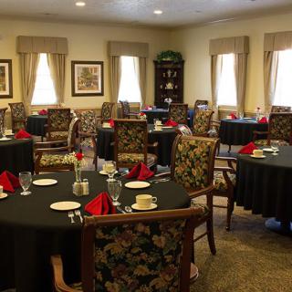 A well-appointed dining room with neatly arranged tables and chairs.