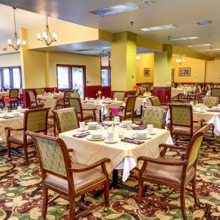 An elegant dining area with neatly arranged tables and chairs, ready for guests.