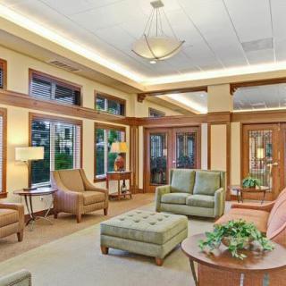 A spacious lounge area with comfortable seating and ample natural light.