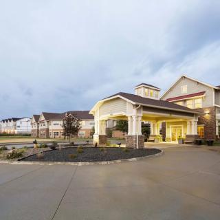 A modern building with a welcoming entrance and driveway.