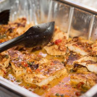 A delicious serving of seasoned baked fish, ready to be enjoyed.