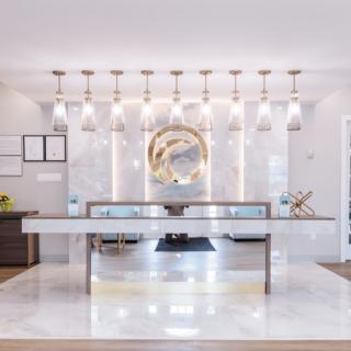 A sleek and modern lobby with a minimalist reception desk and elegant lighting.