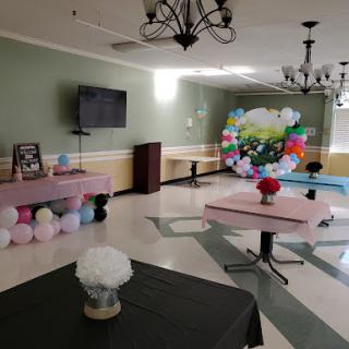 A beautifully decorated event space ready for a celebration, featuring colorful balloons and elegant table settings.