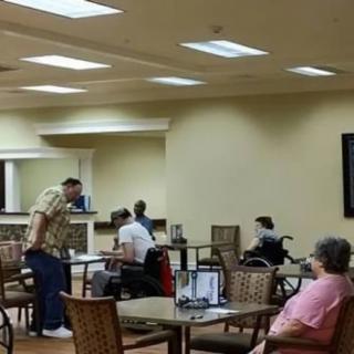 A group of people sitting and chatting in a cozy indoor cafe.