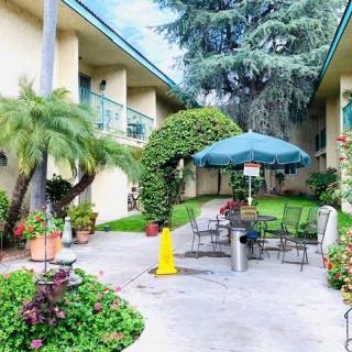 A tranquil courtyard with outdoor seating and lush greenery.