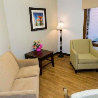 A cozy living room with a sofa, armchair, and decorative elements.