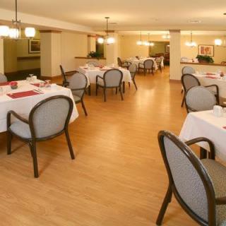An empty restaurant dining area with neatly arranged tables and chairs.
