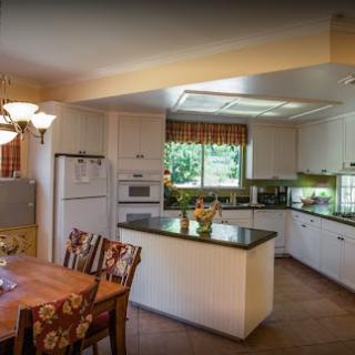 A beautifully designed modern kitchen featuring sleek appliances and a cozy dining area.