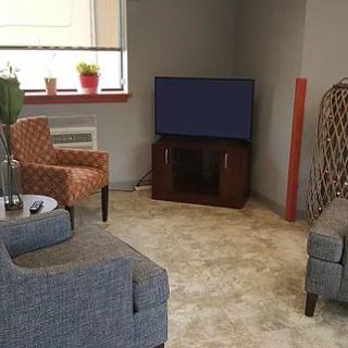 A cozy living room with comfortable seating and a television.