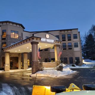 The welcoming entrance of a hotel during a snowy evening.
