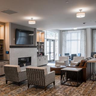 A modern living room with comfortable seating, a fireplace, and a television.