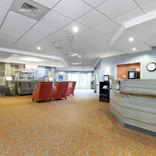 A spacious and modern lobby featuring comfortable seating and a reception desk.