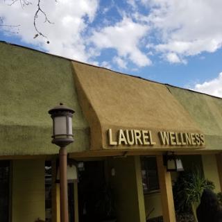 A view of the Laurel Welles building under a partly cloudy sky.