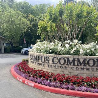 Entrance to Campus Commons Senior Community, showcasing beautiful landscaping and a welcoming sign.
