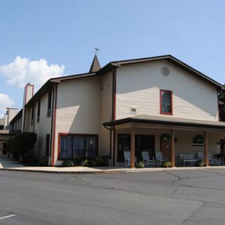 A welcoming hotel building under a clear blue sky.