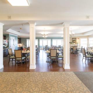 A spacious dining area with neatly arranged tables and chairs.