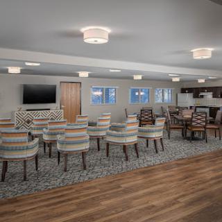A spacious and modern lounge area featuring comfortable seating and stylish lighting.