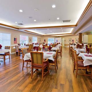 An elegant dining room with neatly arranged tables and chairs.