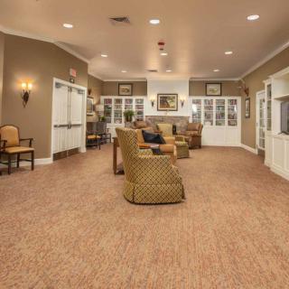 A cozy living room with comfortable seating and warm lighting.