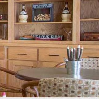 A cozy home interior with a wooden bookshelf and a table holding a container of pencils.