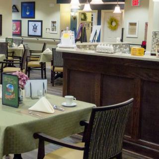 A cozy restaurant interior with neatly arranged tables and a counter area.