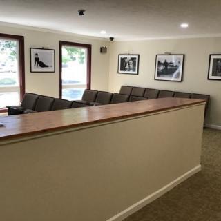 A cozy waiting area with comfortable seating and framed photographs on the walls.