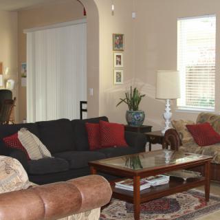 A cozy living room with a sofa, coffee table, and decorative elements.